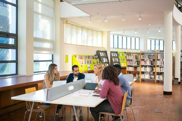 A study group around a table in a library