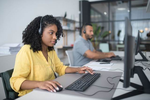 Two people at desktop workstations